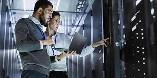 Man and woman in server room 500 x 250