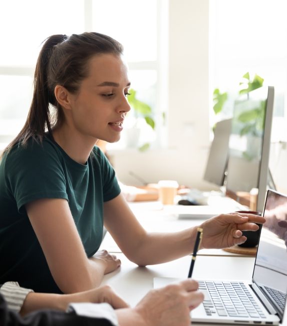 two women tshirt laptop office