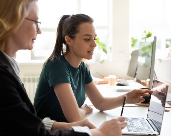 two women tshirt laptop office