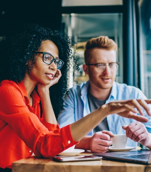 woman in red man in blue laptop