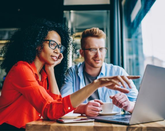 woman in red man in blue laptop