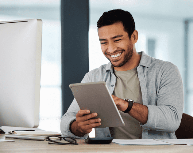 Man smiling at tablet