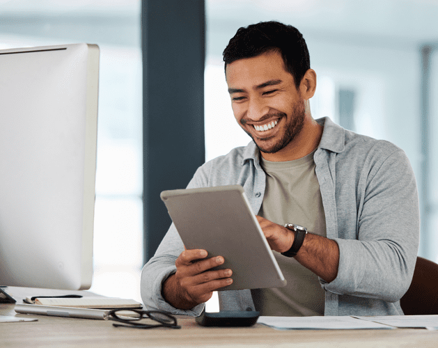 Man smiling at tablet