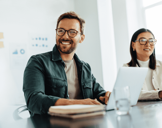 man smiling with laptop